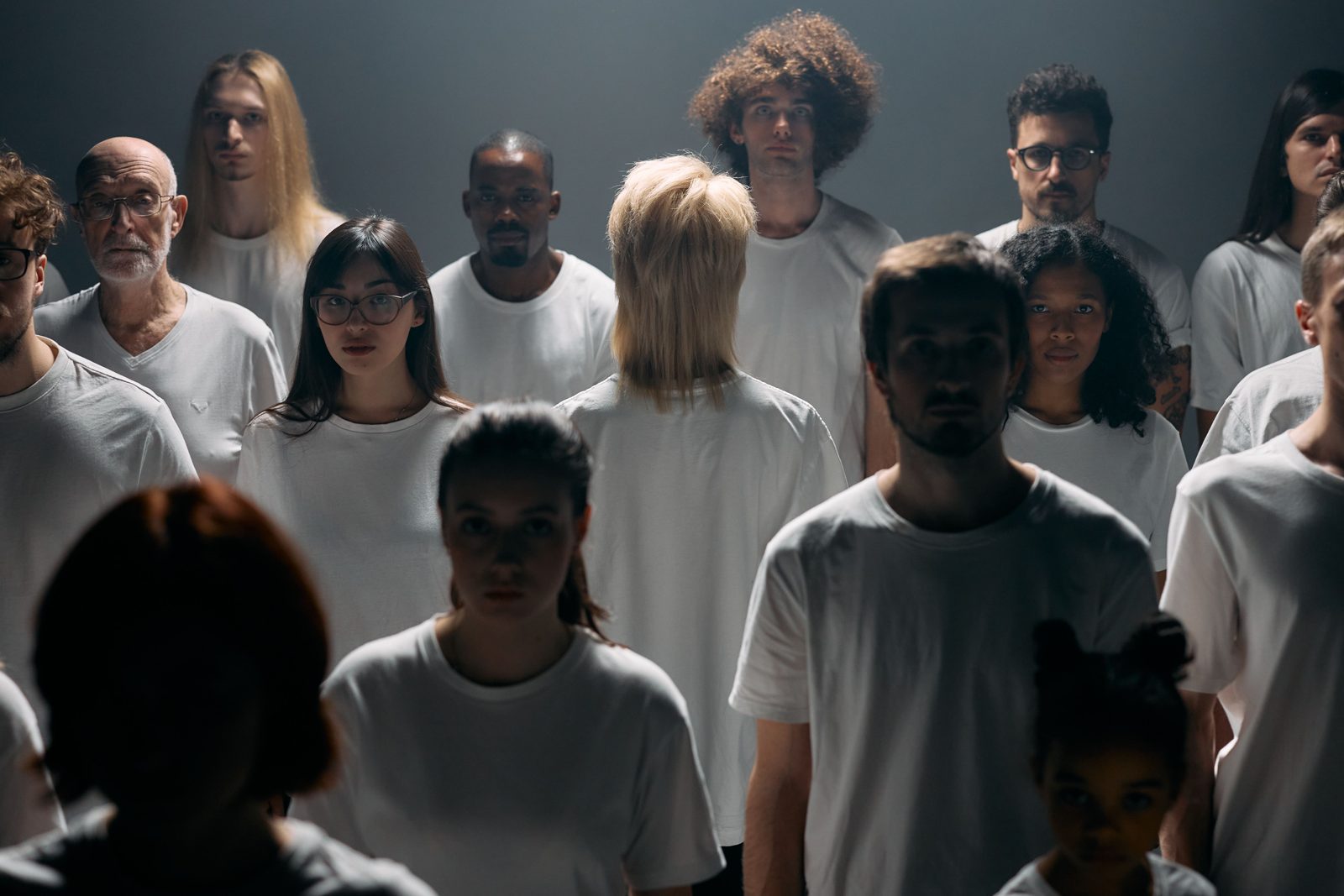 Various people in a darkly lit room